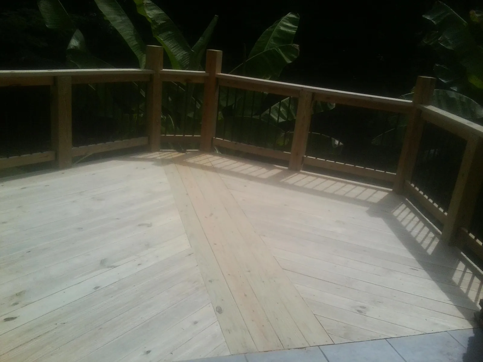 New wood deck and railing built off the back of a home in Sunset Beach